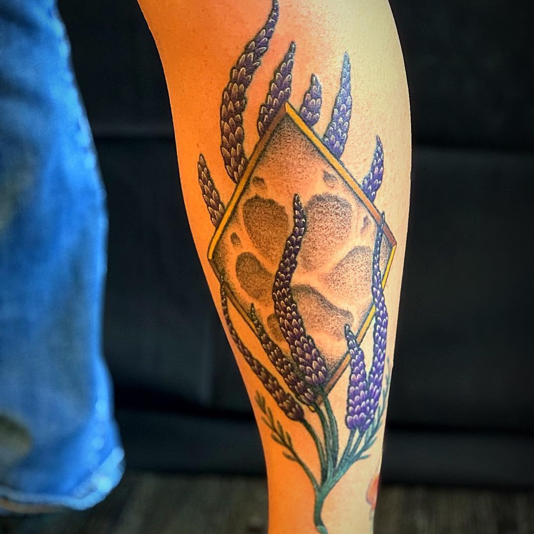 Custom Color Tattoo of Paw Print in Lupins done by Sacred Mandala Studio's tattoo artist Alan Lott in Durham, NC